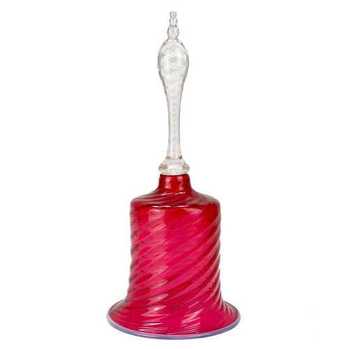 545 - A Victorian cranberry glass handbell. With opaque white spiral twist handle, height 28cm, together w... 