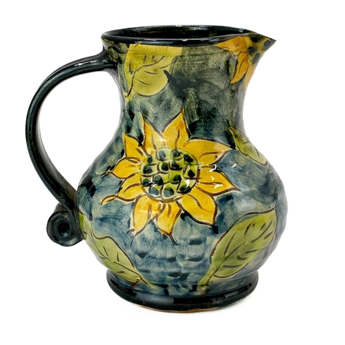 548 - Paul Jackson (1954) Ceramic jug decorated with sunflowers, height 14cm together with another two Pau... 