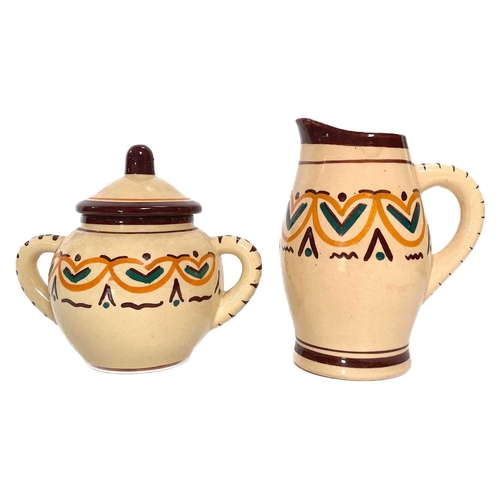 569 - A Quimper pottery tea set. Comprising of a teapot, A two handled lidded sugar bowl, a milk jug, twel... 