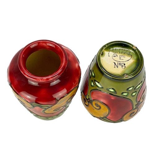 586 - A pair of Minton secessionist vases. Tube lined with stylised trees on a red and green ground, print... 