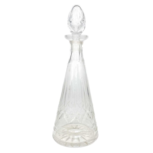 589 - A set of three cut glass decanters and faceted stoppers. One with a silver Whisky label, together wi... 