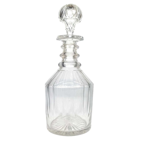 589 - A set of three cut glass decanters and faceted stoppers. One with a silver Whisky label, together wi... 