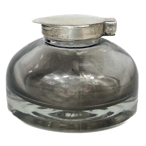 589 - A set of three cut glass decanters and faceted stoppers. One with a silver Whisky label, together wi... 