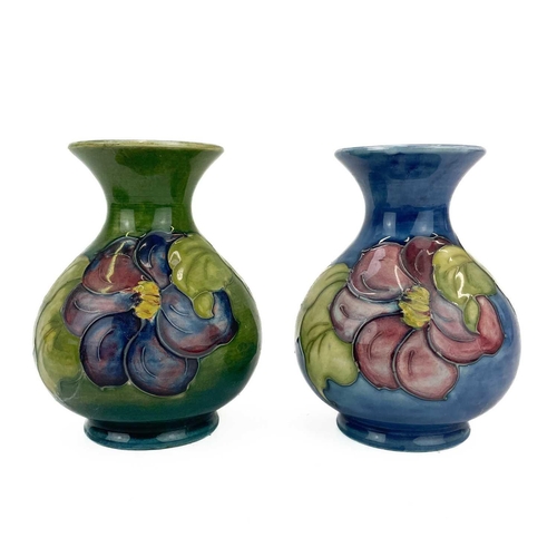 590 - A Moorcroft pottery Anemone vase. Height 13cm together with another similar and a Moorcroft pottery ... 