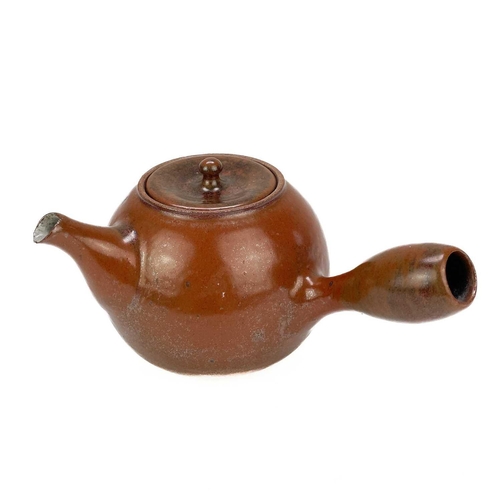 597 - Jacob Bodilly A stoneware side handled teapot with tomato glaze, applied potters seal, height 12cm.