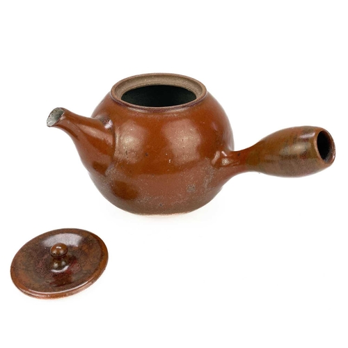 597 - Jacob Bodilly A stoneware side handled teapot with tomato glaze, applied potters seal, height 12cm.