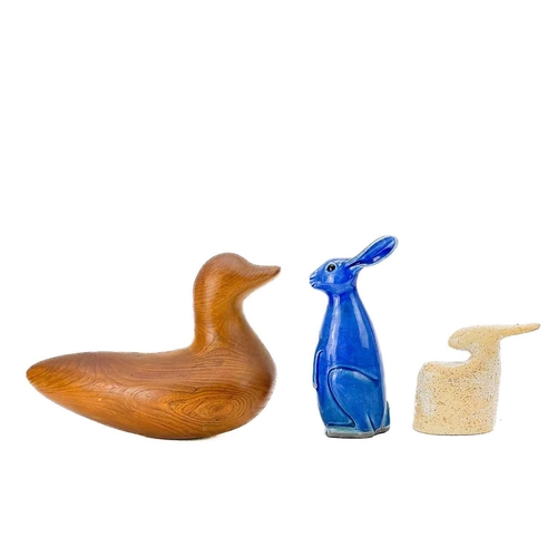 598 - A yew carved duck decoy. Height 20cm, together with two ironwork model cows, steel fish, studio pott... 