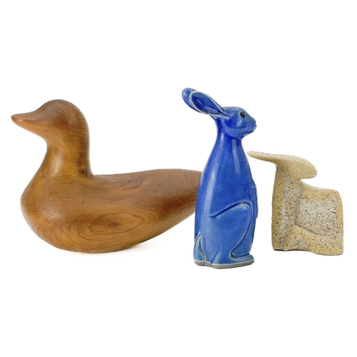 598 - A yew carved duck decoy. Height 20cm, together with two ironwork model cows, steel fish, studio pott... 