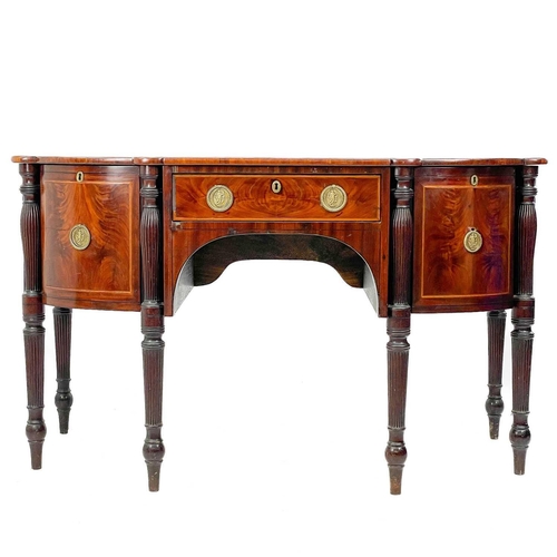 601 - A Regency mahogany sideboard. Of broken D shape outline, fitted a central drawer, flanked by two dee... 