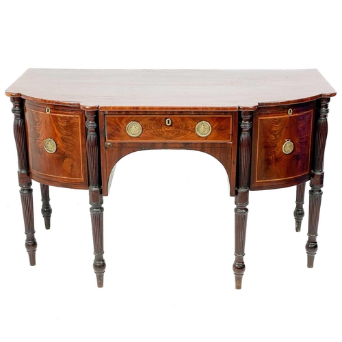 601 - A Regency mahogany sideboard. Of broken D shape outline, fitted a central drawer, flanked by two dee... 