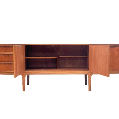 608 - A mid century teak sideboard by A H McIntosh & Co Ltd. With twin central cupboard doors flanked by a... 