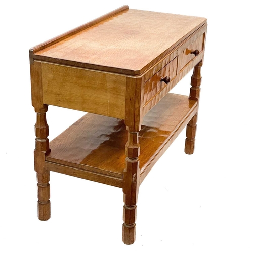 610 - A Robert 'Mouseman' Thompson of Kilburn oak side table. With two short drawers and a tiered stretche... 