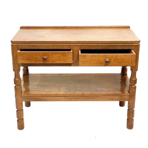 610 - A Robert 'Mouseman' Thompson of Kilburn oak side table. With two short drawers and a tiered stretche... 