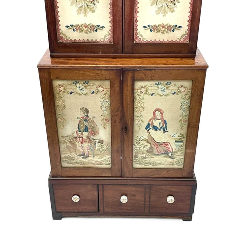 613 - A 19th century walnut and mahogany bookcase. With embroidered panels enclosing various shelves, the ... 