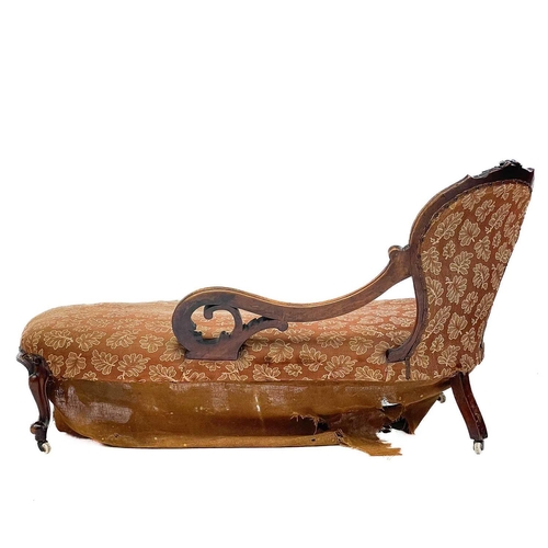 614 - A mid 19th century walnut chaise longue. With foliate scroll carved open arm supports on cabriole le... 