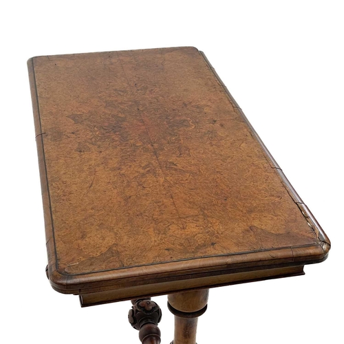 624 - A Victorian fold top burr walnut card table. With baized interior and raised on turned legs and a st... 