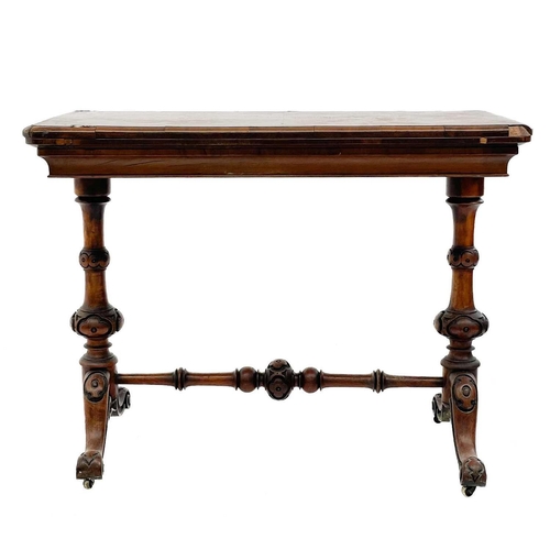 624 - A Victorian fold top burr walnut card table. With baized interior and raised on turned legs and a st... 