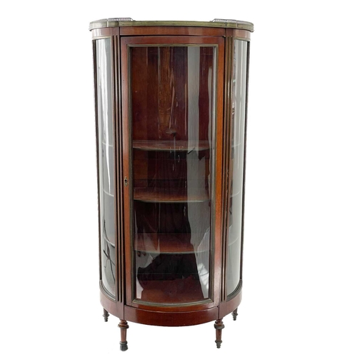 635 - A marble top mahogany vitrine. Circa 1900, with pierced brass gallery and of half round section, on ... 