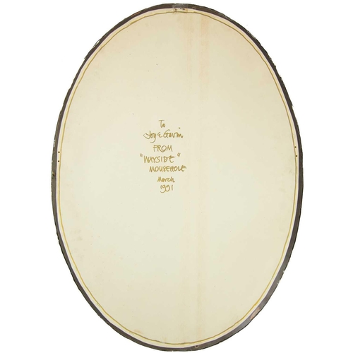 638 - An Art Nouveau plated copper oval wall mirror. With a planished finish and set with four Ruskin styl... 