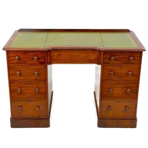 639 - A Victorian mahogany fixed pedestal desk. With a green leather skiver an arrangement of nine drawers... 