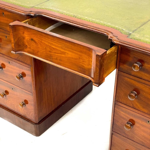 639 - A Victorian mahogany fixed pedestal desk. With a green leather skiver an arrangement of nine drawers... 