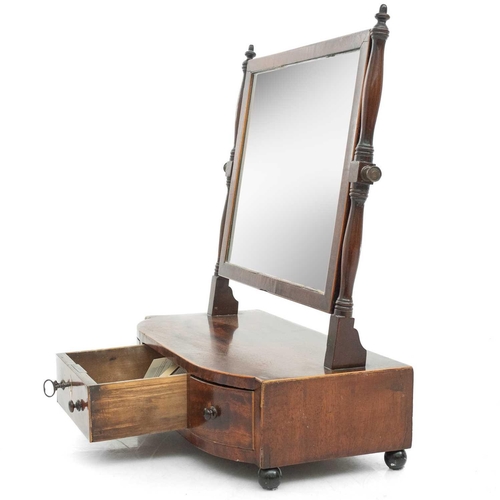 640 - A William IV mahogany swing toilet mirror. The bow front base fitted one long and two short drawers,... 