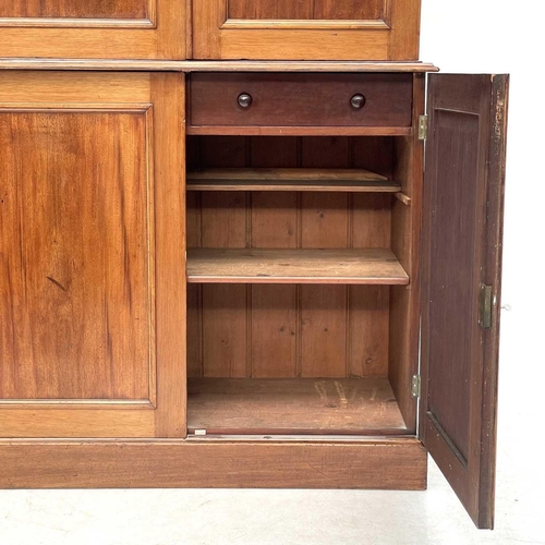 643 - A Victorian mahogany two-part estate cupboard. The upper part with a moulded cornice above two doors... 