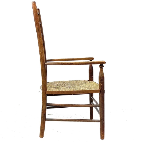 647 - A beech ladderback nursing chair labelled Liberty. With rush seat, height 85.5cm width 47cm depth 42... 