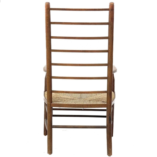 647 - A beech ladderback nursing chair labelled Liberty. With rush seat, height 85.5cm width 47cm depth 42... 