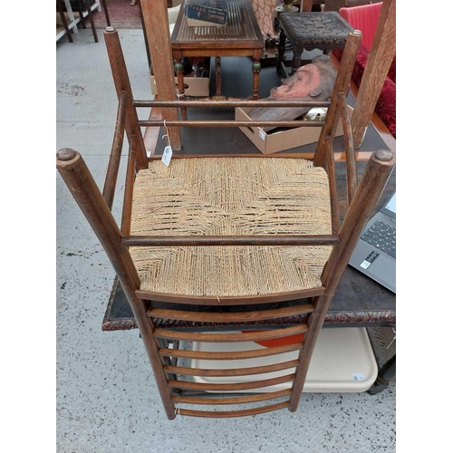 647 - A beech ladderback nursing chair labelled Liberty. With rush seat, height 85.5cm width 47cm depth 42... 