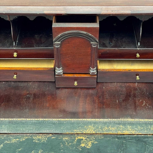 650 - A George III mahogany bureau. With a well fitted interior of stepped drawers, pigeon holes and compa... 