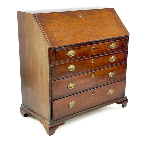 650 - A George III mahogany bureau. With a well fitted interior of stepped drawers, pigeon holes and compa... 