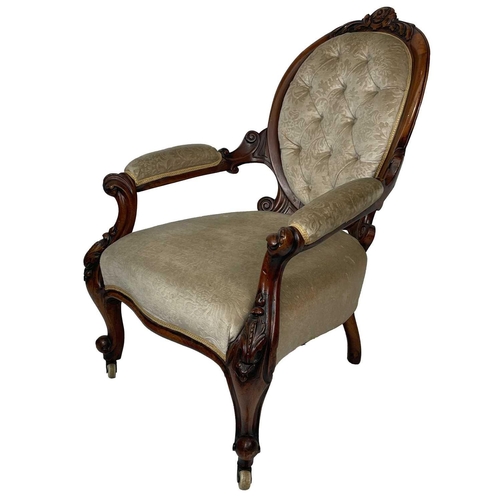 652 - A Victorian walnut upholstered serpentine fronted open armchair. Carved with foliate scrolls, on cer... 