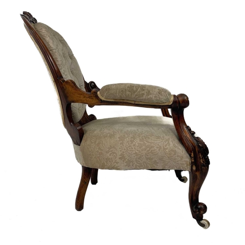 652 - A Victorian walnut upholstered serpentine fronted open armchair. Carved with foliate scrolls, on cer... 