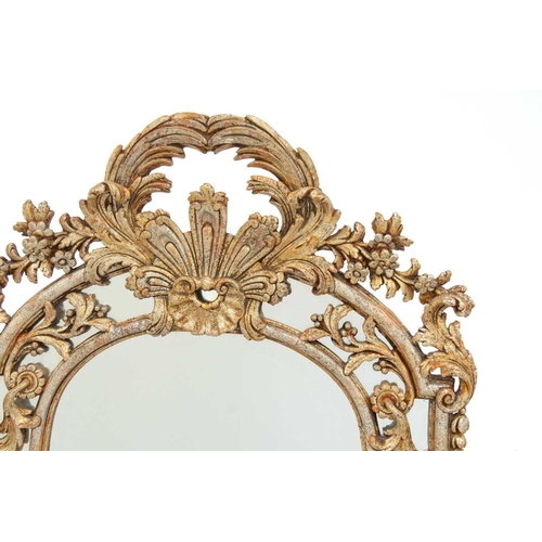 655 - A large gilt wood rococo style overmantle mirror. Carved with foliate scrolls, height 167cm width 15... 