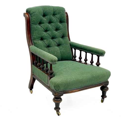 657 - A Victorian mahogany framed armchair. with button back and upholstered sprung seat, the padded arms ... 