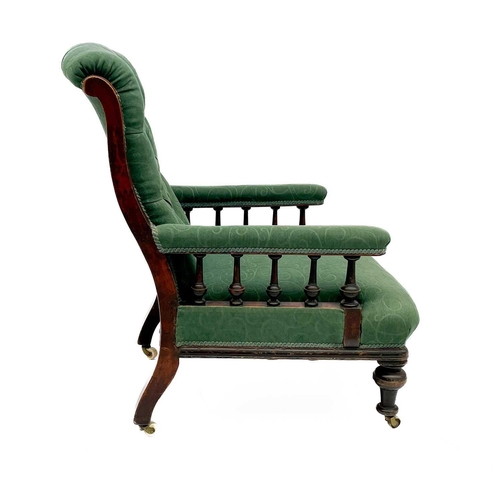 657 - A Victorian mahogany framed armchair. with button back and upholstered sprung seat, the padded arms ... 