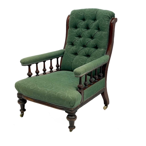 657 - A Victorian mahogany framed armchair. with button back and upholstered sprung seat, the padded arms ... 