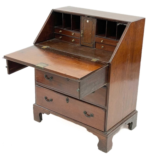 671 - A mahogany and oak bureau. 19th century, the fall front enclosing a fitted interior above three long... 