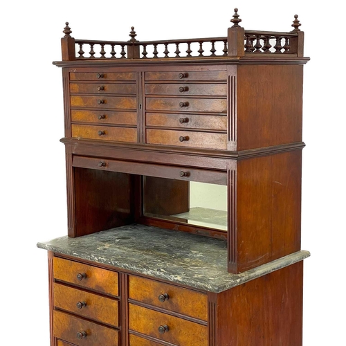 686 - A late Victorian walnut dentist's cabinet. With a galleried top above ten graduated drawers with a t... 