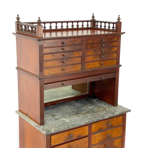 686 - A late Victorian walnut dentist's cabinet. With a galleried top above ten graduated drawers with a t... 