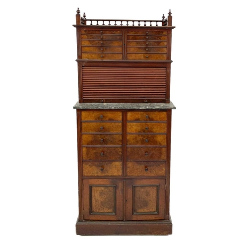 686 - A late Victorian walnut dentist's cabinet. With a galleried top above ten graduated drawers with a t... 