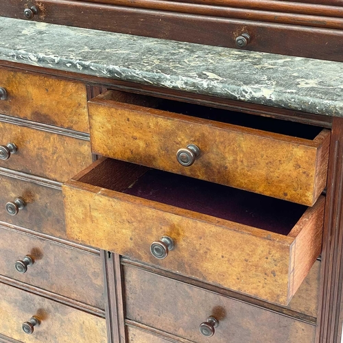 686 - A late Victorian walnut dentist's cabinet. With a galleried top above ten graduated drawers with a t... 