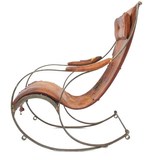 687 - A campaign rocking chair possibly manufactured by R W Winfield Strip steel frame with distressed lea... 