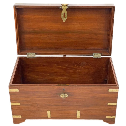 689 - A brass bound teak campaign style small chest. 20th century, with twin brass handles and bracket fee... 