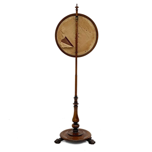 691 - A Victorian walnut pole screen. The circular banner with scrolling foliage in gilt metal thread, on ... 