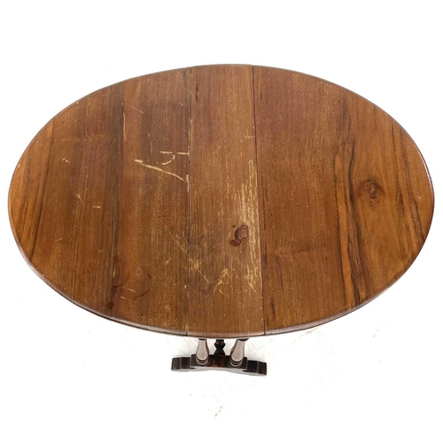 692 - A late Victorian small oval walnut drop leaf Sutherland table. With turned legs and a stretcher, hei... 