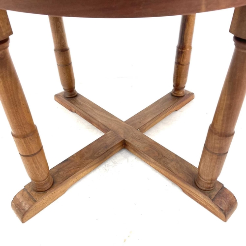 694 - A Robin Nance circular walnut occasional table. Raised on turned square section legs, with an X stre... 