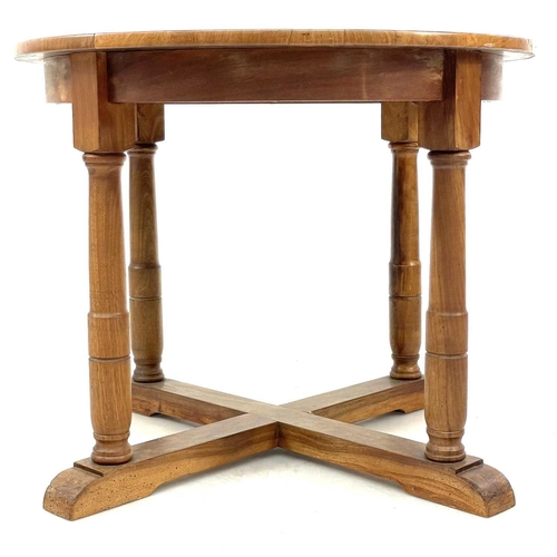 694 - A Robin Nance circular walnut occasional table. Raised on turned square section legs, with an X stre... 