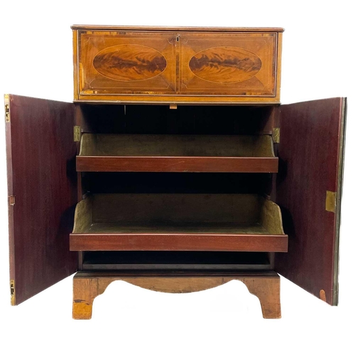 696 - A George III style mahogany secretaire. With oval figured and rosewood banded drop front, enclosing ... 